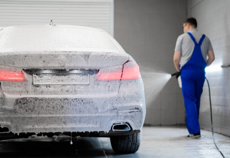 Car bodywork covered in cleaning foam during an exterior wash
